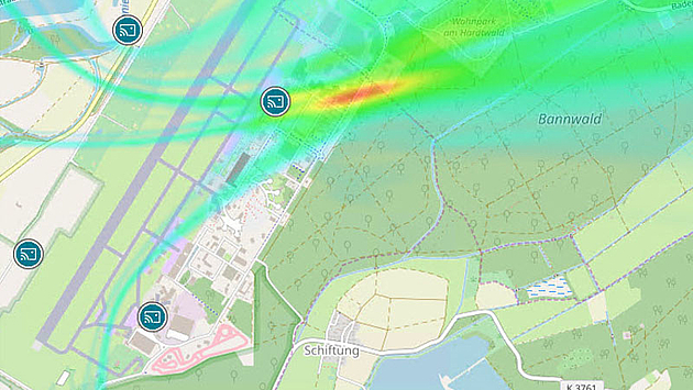Heatmap result for TDOA analysis of a cellular signal Street map showing 4 monitoring stations as icons and the result of the TDOA analysis as a heatmap. The heatmap shows the probability of the searched emitter being at a particular location from blue to red. Red represents the highest probability.