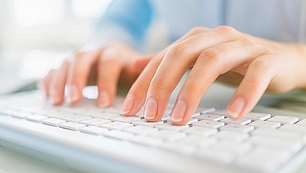 Newsletter Subscription for Industry Updates Hands typing on a keyboard represent newsletter updates on spectrum management, events and company news.