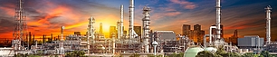 Spectrum licensing support for industrial facilities Industrial site at sunset representing spectrum licensing for refineries, ports, and factories