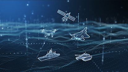 Advanced Spectrum Management Solutions for Defense Operations Digital hologram visualization of military assets including satellite, drone, fighter jet, naval ship, and tank over a data network background, representing defense communication and spectrum management technology.